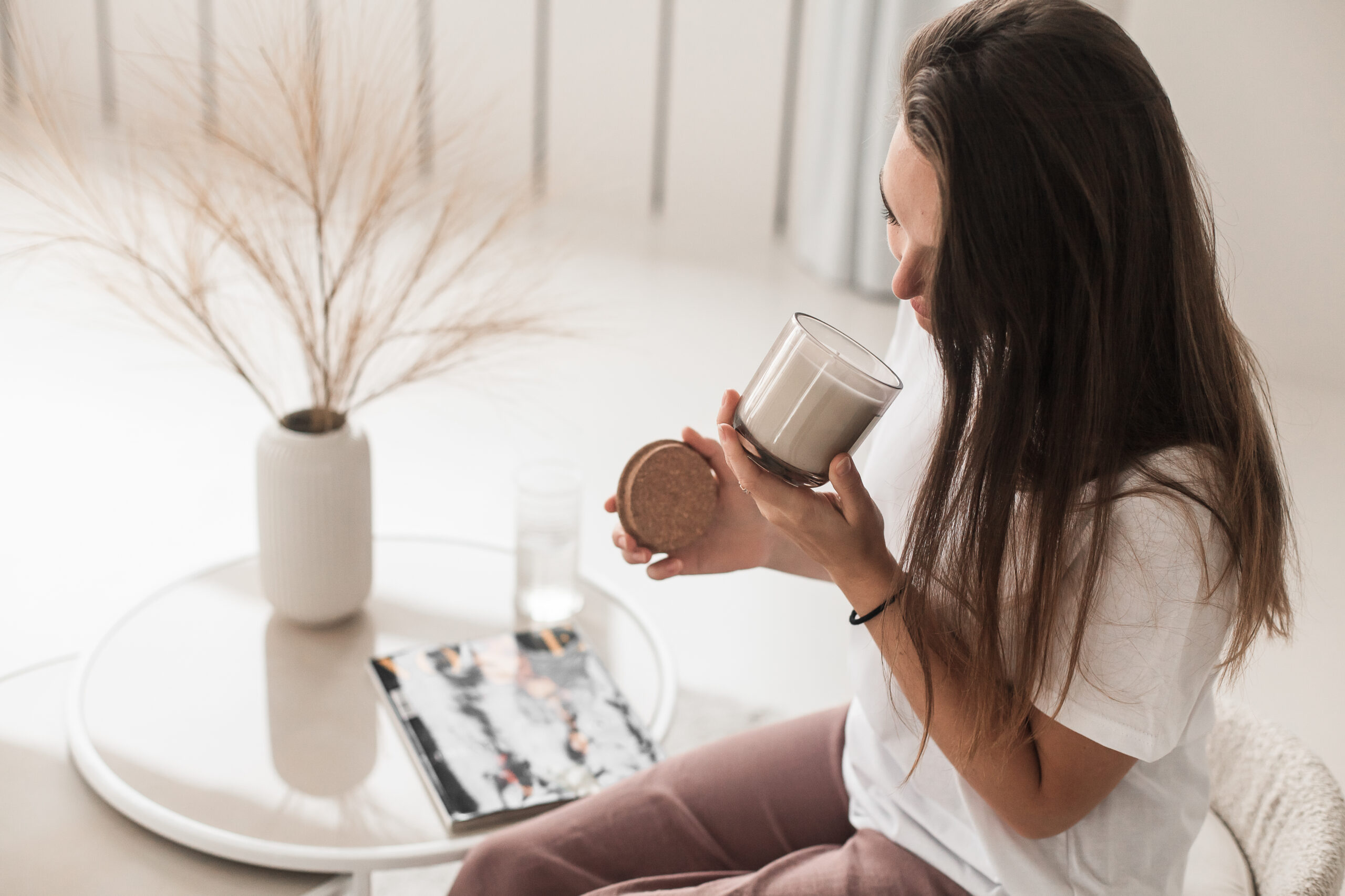 russian girl sitting chair smelling candle(1)